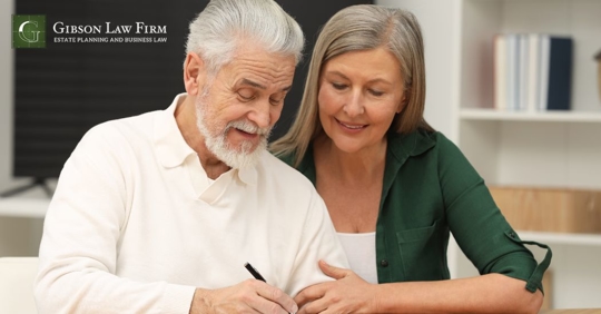 old couple signing a document